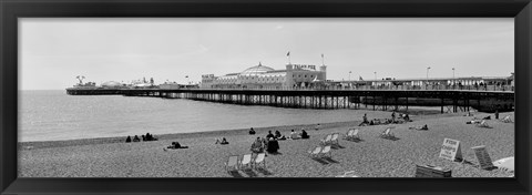 Framed Tourists on the beach, Brighton, England Print