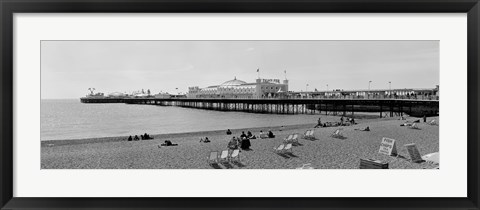 Framed Tourists on the beach, Brighton, England Print