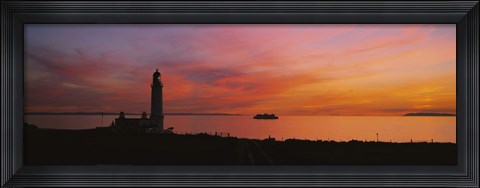 Framed Silhouette of a lighthouse at sunset, Scotland Print