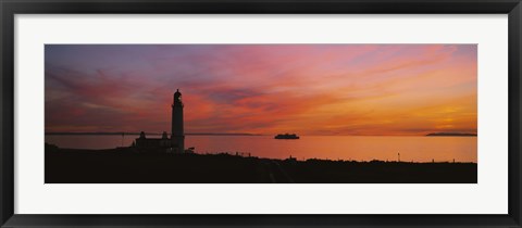 Framed Silhouette of a lighthouse at sunset, Scotland Print