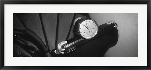 Framed Man Carrying Clock Up Stairs On Shoulders Print