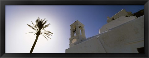 Framed Low angle view of a palm tree near a church , Ios, Cyclades Islands, Greece Print