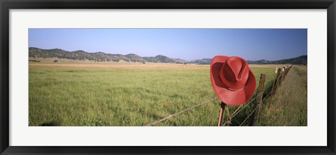 Framed USA, California, Red cowboy hat hanging on the fence Print