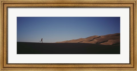 Framed USA, Colorado, Great Sand Dunes National Monument, Runner jogging in the park Print