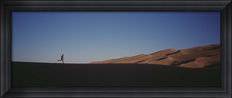 Framed USA, Colorado, Great Sand Dunes National Monument, Runner jogging in the park Print