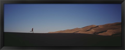 Framed USA, Colorado, Great Sand Dunes National Monument, Runner jogging in the park Print