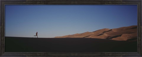 Framed USA, Colorado, Great Sand Dunes National Monument, Runner jogging in the park Print