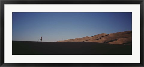 Framed USA, Colorado, Great Sand Dunes National Monument, Runner jogging in the park Print