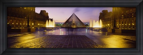 Framed Museum lit up at night with ghosted image of three men, Louvre Museum, Paris, France Print
