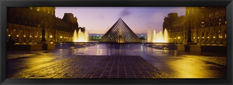 Framed Museum lit up at night with ghosted image of three men, Louvre Museum, Paris, France Print