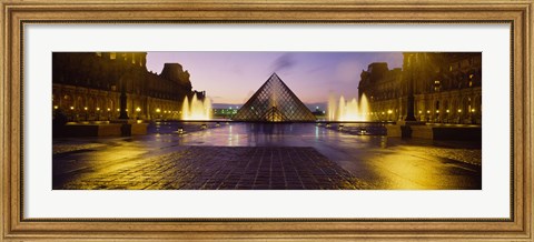 Framed Museum lit up at night with ghosted image of three men, Louvre Museum, Paris, France Print