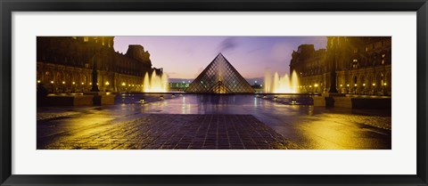 Framed Museum lit up at night with ghosted image of three men, Louvre Museum, Paris, France Print