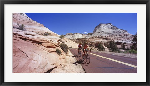 Framed Two people cycling on the road, Zion National Park, Utah, USA Print