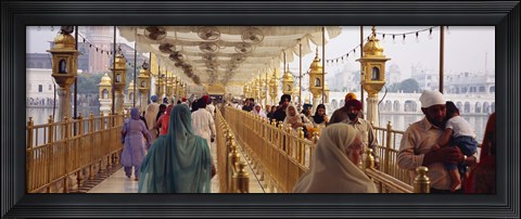 Framed Group of people walking on a bridge over a pond, Golden Temple, Amritsar, Punjab, India Print