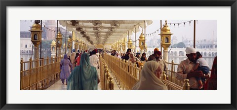 Framed Group of people walking on a bridge over a pond, Golden Temple, Amritsar, Punjab, India Print