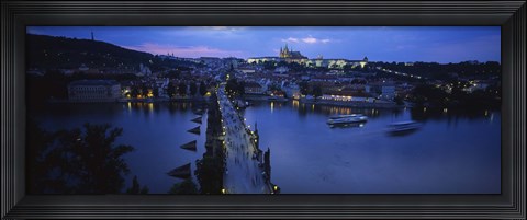 Framed High angle view of buildings lit up at dusk, Charles Bridge, Vltava River, Prague, Czech Republic Print