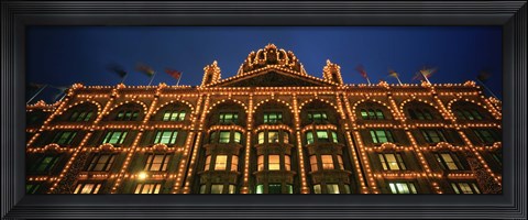 Framed Low angle view of a building lit up at night, Harrods, London, England Print