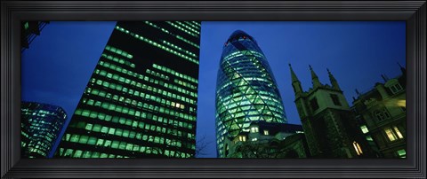 Framed Low angle view of buildings lit up at night, Sir Norman Foster Building, Swiss Re Tower, London, England Print