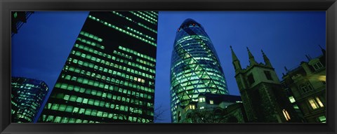 Framed Low angle view of buildings lit up at night, Sir Norman Foster Building, Swiss Re Tower, London, England Print
