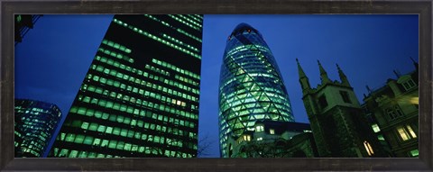Framed Low angle view of buildings lit up at night, Sir Norman Foster Building, Swiss Re Tower, London, England Print