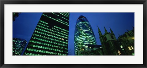 Framed Low angle view of buildings lit up at night, Sir Norman Foster Building, Swiss Re Tower, London, England Print