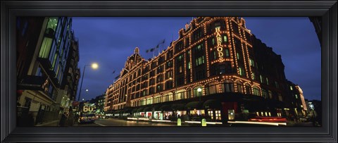 Framed Low angle view of buildings lit up at night, Harrods, London, England Print