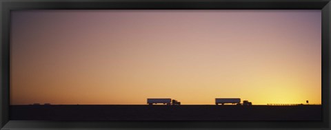 Framed Silhouette of two trucks moving on a highway, Interstate 5, California, USA Print