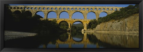 Framed Reflection of an arch bridge in a river, Pont Du Gard, France Print