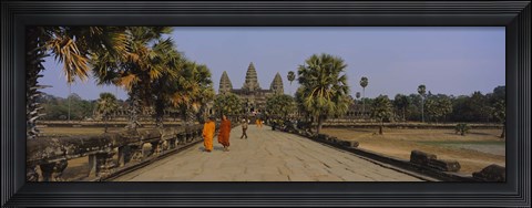 Framed Two monks walking in front of an old temple, Angkor Wat, Siem Reap, Cambodia Print