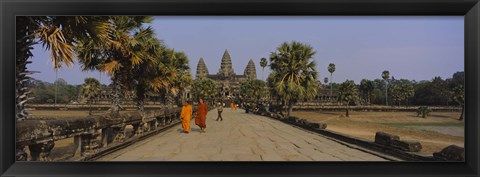 Framed Two monks walking in front of an old temple, Angkor Wat, Siem Reap, Cambodia Print