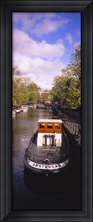 Framed Tourboat docked in a channel, Amsterdam, Netherlands Print