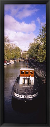 Framed Tourboat docked in a channel, Amsterdam, Netherlands Print