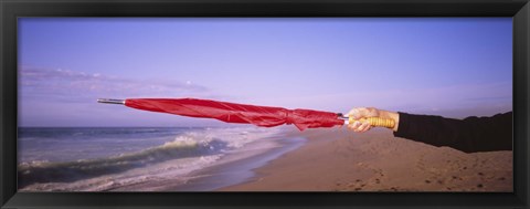 Framed Close-up of a woman&#39;s hand pointing with a red umbrella, Point Reyes National Seashore, California, USA Print