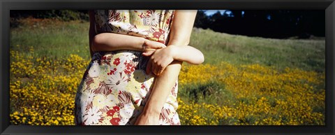 Framed Mid section view of a girl hugging her mother in a field, Marin County, California, USA Print