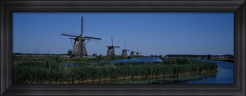 Framed Traditional windmills at a riverbank, Kinderdijk, Rotterdam, Netherlands Print