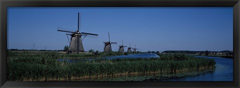 Framed Traditional windmills at a riverbank, Kinderdijk, Rotterdam, Netherlands Print