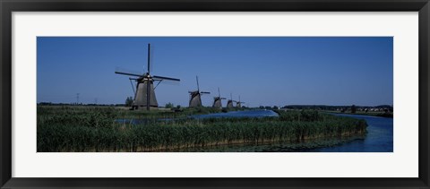 Framed Traditional windmills at a riverbank, Kinderdijk, Rotterdam, Netherlands Print