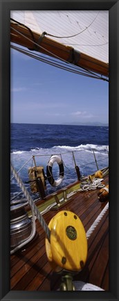 Framed Detail of the mainsheet block of a wooden sailboat in the sea Print