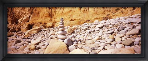 Framed Stack of stones on the beach, California, USA Print