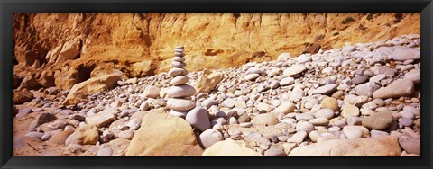 Framed Stack of stones on the beach, California, USA Print
