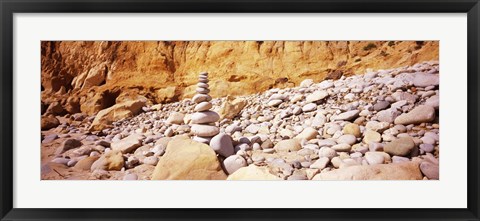 Framed Stack of stones on the beach, California, USA Print