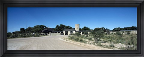 Framed Road leading towards the entrance of a rest camp, Okaukuejo, Etosha National Park, Kunene Region, Namibia Print