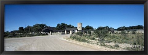 Framed Road leading towards the entrance of a rest camp, Okaukuejo, Etosha National Park, Kunene Region, Namibia Print