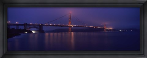 Framed Suspension bridge lit up at dawn viewed from fishing pier, Golden Gate Bridge, San Francisco Bay, San Francisco, California, USA Print