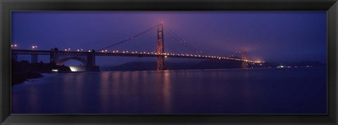 Framed Suspension bridge lit up at dawn viewed from fishing pier, Golden Gate Bridge, San Francisco Bay, San Francisco, California, USA Print