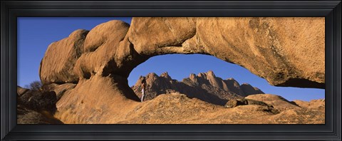 Framed Mountains viewed through a natural arch with a mother holding her baby, Spitzkoppe, Namib Desert, Namibia Print