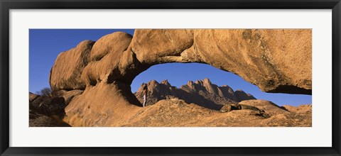 Framed Mountains viewed through a natural arch with a mother holding her baby, Spitzkoppe, Namib Desert, Namibia Print