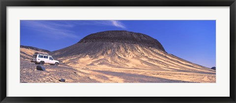 Framed SUV moving in a desert, Black Desert, Bahariya Oasis, Egypt Print