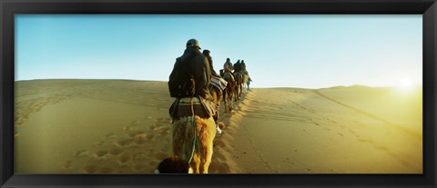 Framed Row of people riding camels through the desert, Sahara Desert, Morocco Print