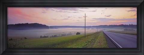 Framed Country road and telephone lines splitting farmlands at dawn, Finland Print